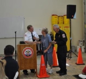 Ron Miller, president of the Chester County Fire Police Association, congratulates Louise and Bob Massey. Louise Massey and Bob Massey