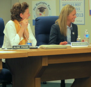 School Director Aline Frank (from left) applauds as Heather Schaen wins approval as the next board president.