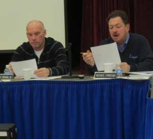 Board Member Michael Finnegan (right) discusses the preliminary 2014-2015 budget as D