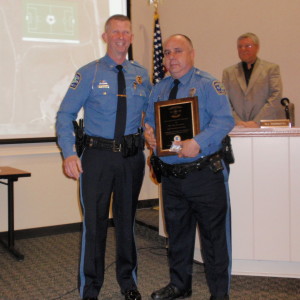 New Garden Police Officer Mario Raimato (right) holds the plaque he received from Police Chief Gerald R. Simpson, which honored his as 2012 Police Officer of the Year.