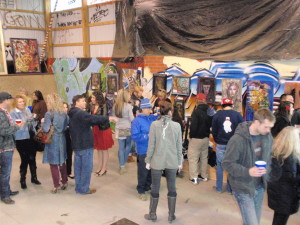 Spectators mingle and survey the art at Bam Margera’s skate park, which doubled as a gallery Tuesday night.