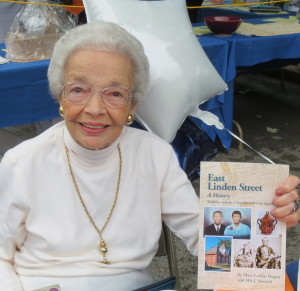 Ella J. Sestrich displays the book she co-authored with the late Mary Larkin Dugan, an advocate of the East Linden Street Project who was honored at the gala.