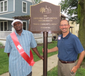 Historic East Linden Street Project board member Barry "Hap" London (from left) shows off the neighborhood's new plaque with Kennett Square Borough Council President Dan Maffei. 