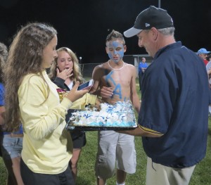 KAU videographer passes out cake during the welcome-home celebration Sunday night, an event praised for its demonstration of community spirit at the Unionville-Chadds Ford school board meeting.