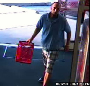 Police said this surveillance camera shows the suspect with the shopping basket he used to steal baby formula.