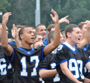 As TV cameras roll, members of the Kennett High football team attempt to generate excitement  among students for tonight's game. 