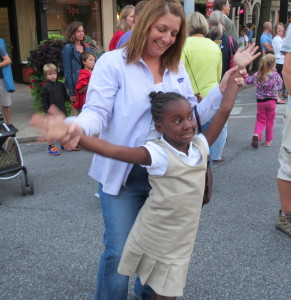 Energized by the band, Good Foot, 5-year-old Catrina Mackovjak, with her mother, Fran, takes a brief break from her whirling dance moves on State Street.