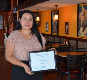 Josefina Nino of El Ranchero Mexican Restaurant shows off the certificate the eatery received in the salsa competition.
