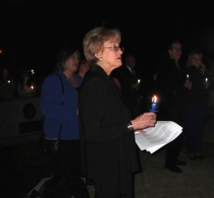 Peggy Gusz, executive director of the Crime Victims’ Center of Chester County, listens to remarks at the Victims’ Memorial in Downingtown’s Kardon Park.