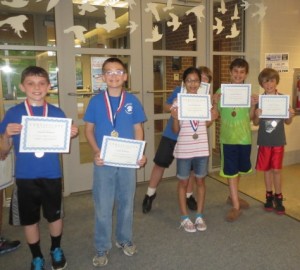 Some of the elementary-school math winners proudly show off their certificates.