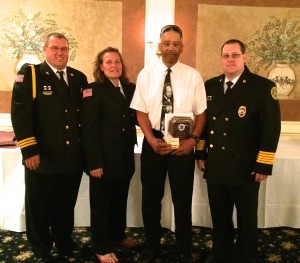 Earl Taylor (third from left) poses with EMS officials after receiving the BLS Provider of the Year award.