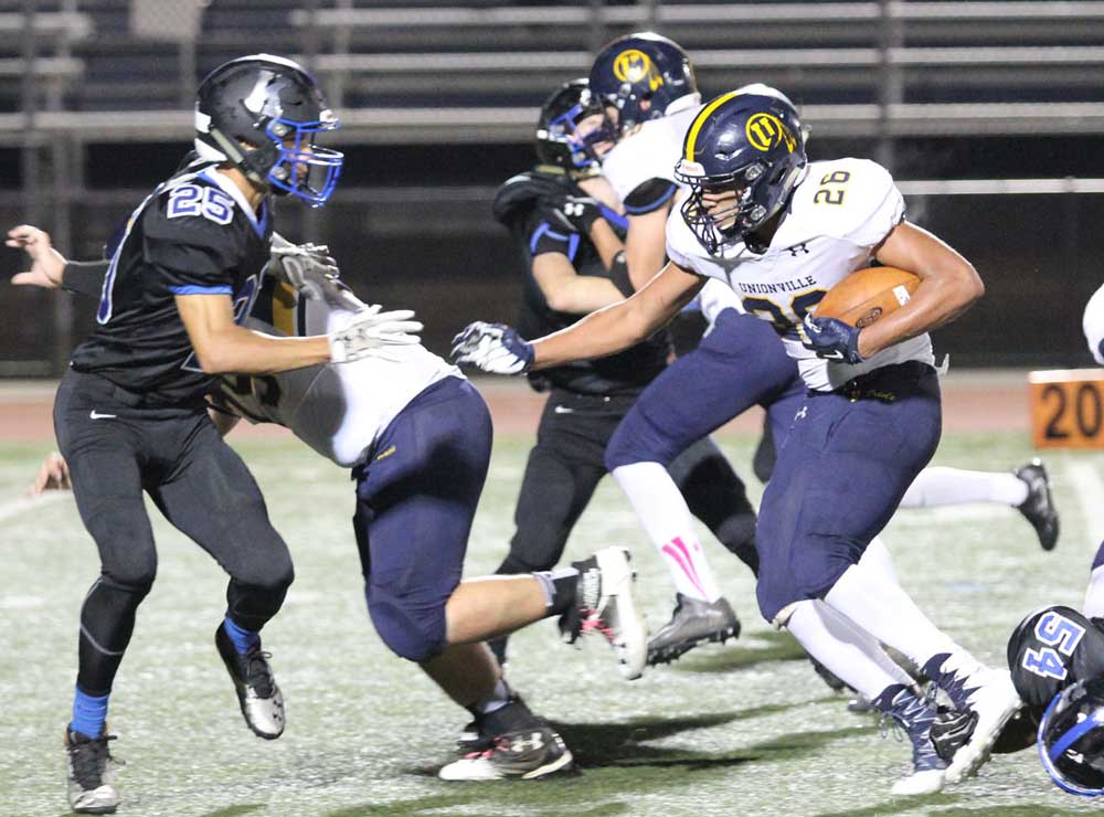 Unionville's Dante Graham rips off a run against Kennett. Graham's strong second half helped power a dominating second Indian run game. Jim Gill photo.